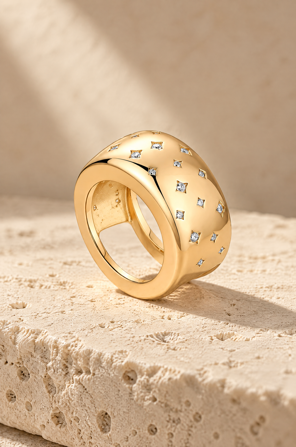Gold Stromboli starburst ring cover on travertine