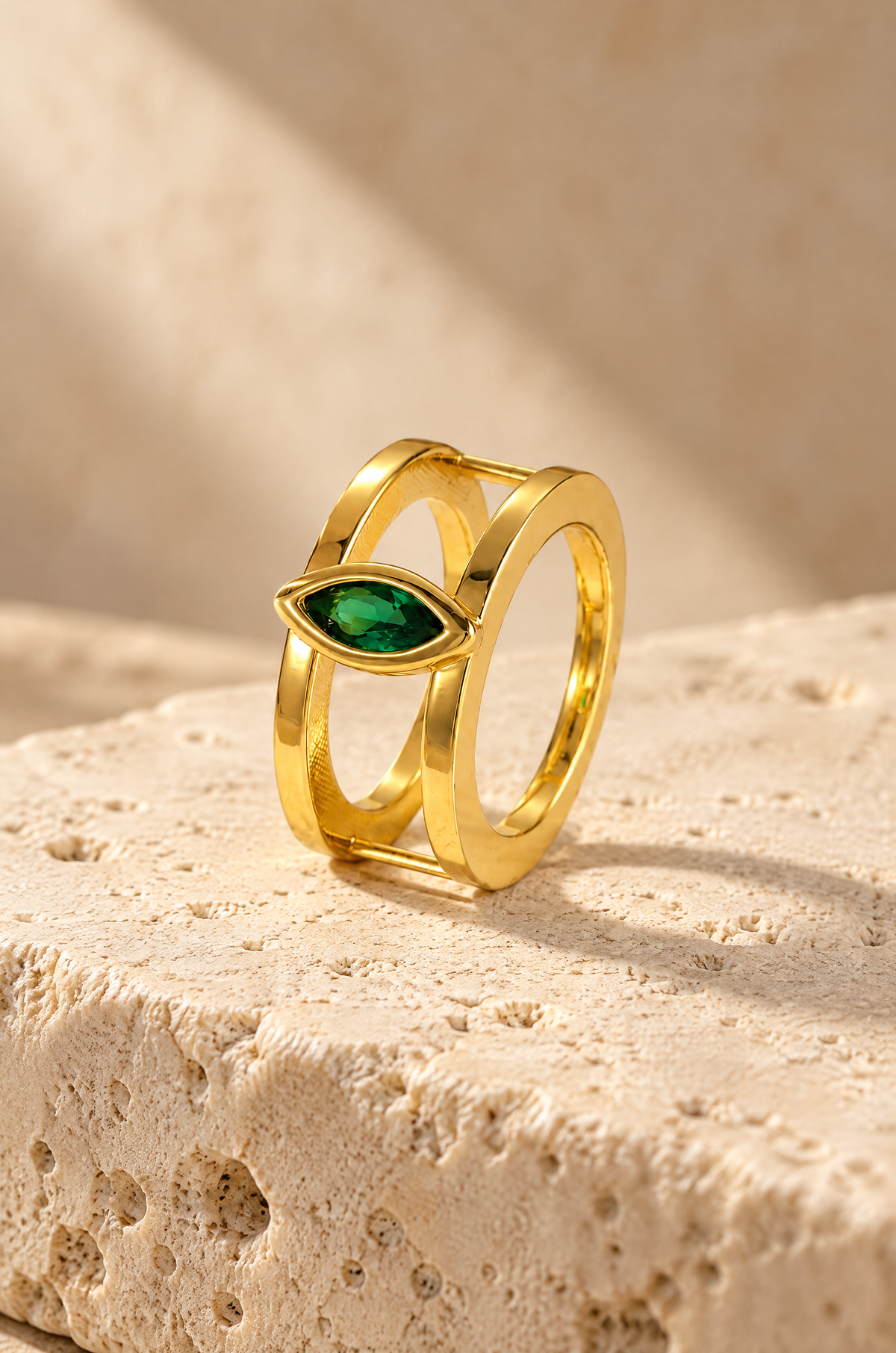 Gold Cefalù marquise ring cover on travertine
