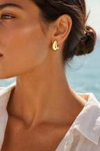 Dome earrings worn, sunlit