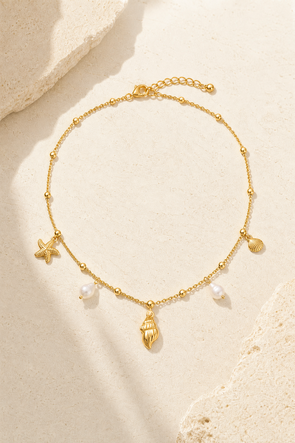 Cetara shell necklace in 18k gold with starfish, conch and pearl charms