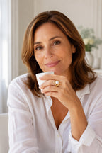 Woman holding an espresso cup wearing the Atrani Orbit Ring