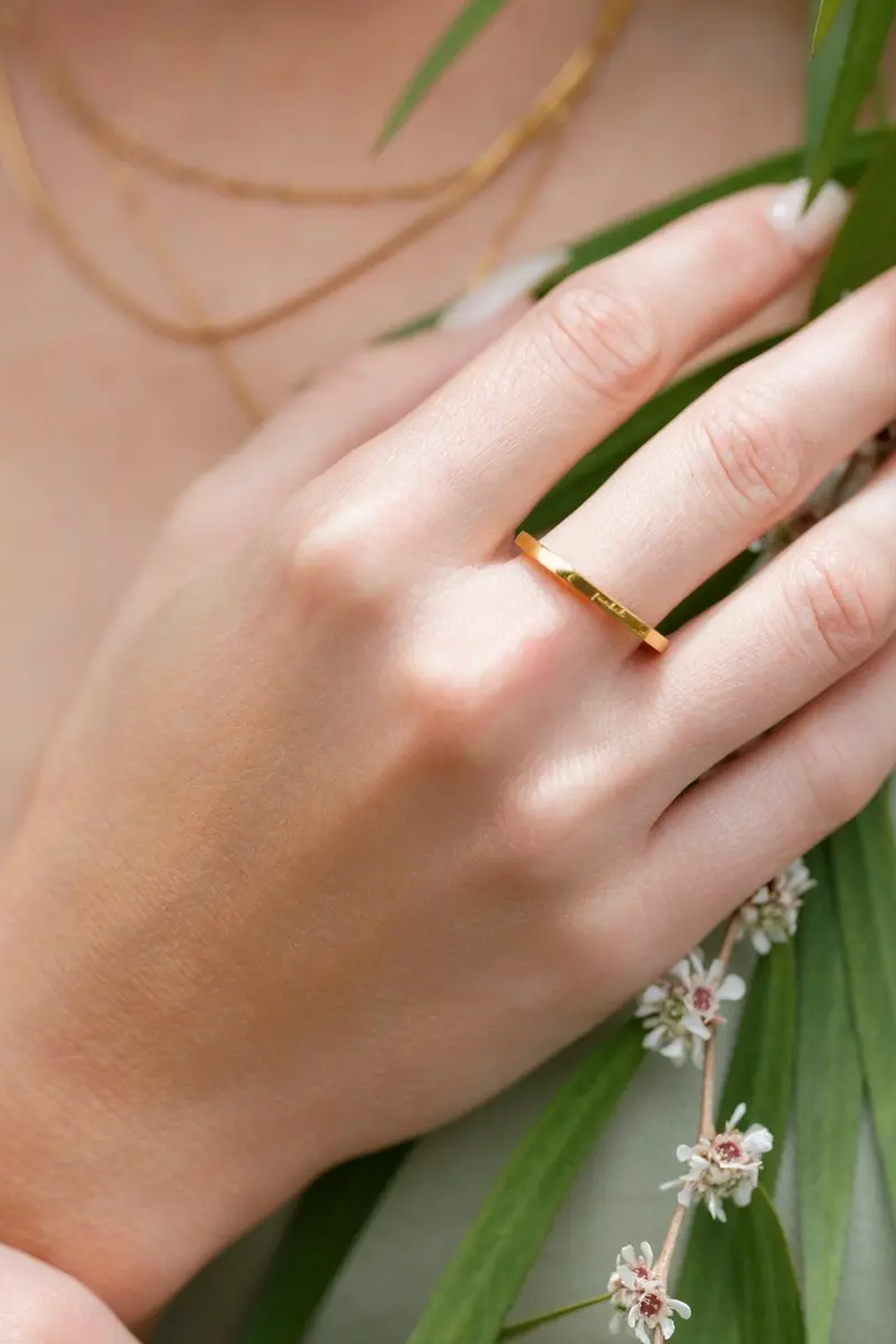 Basta Band gold ring worn on a hand