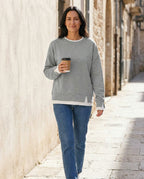 Woman wearing the Bruma layered sweatshirt with a white tee