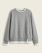 Bruma layered sweatshirt on a plain off-white background