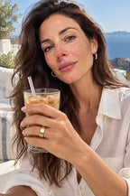 Woman on a terrace wearing a gold Faraglioni cover