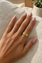 Hand wearing a gold Faraglioni cover
