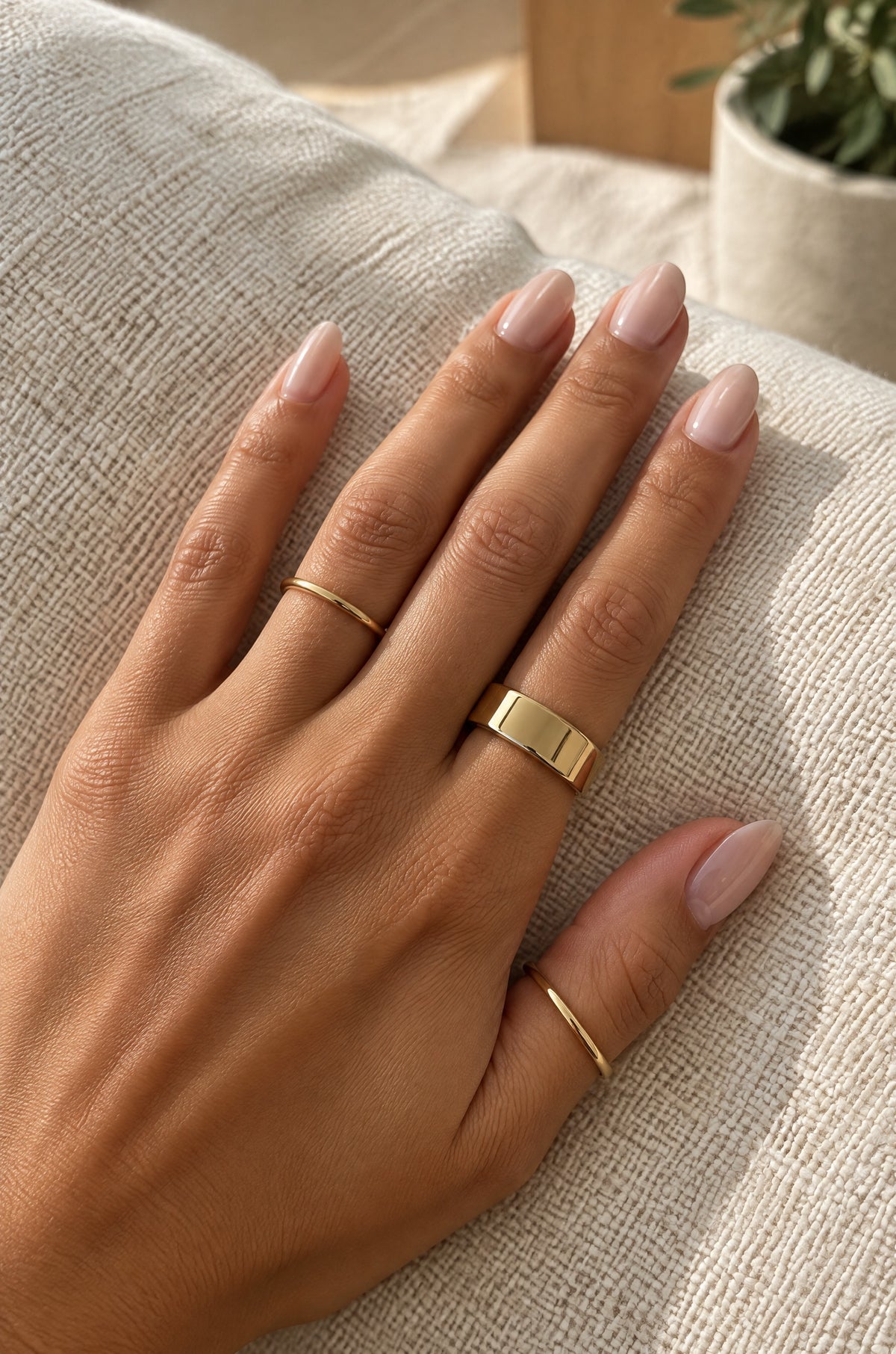 Hand wearing a gold Faraglioni cover