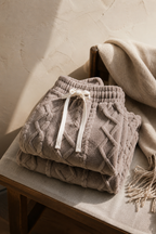Agerola fleece pant in brown, folded on a chair