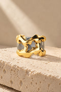 Filicudi ring cover in gold on travertine