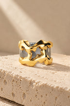 Filicudi ring cover in gold on travertine