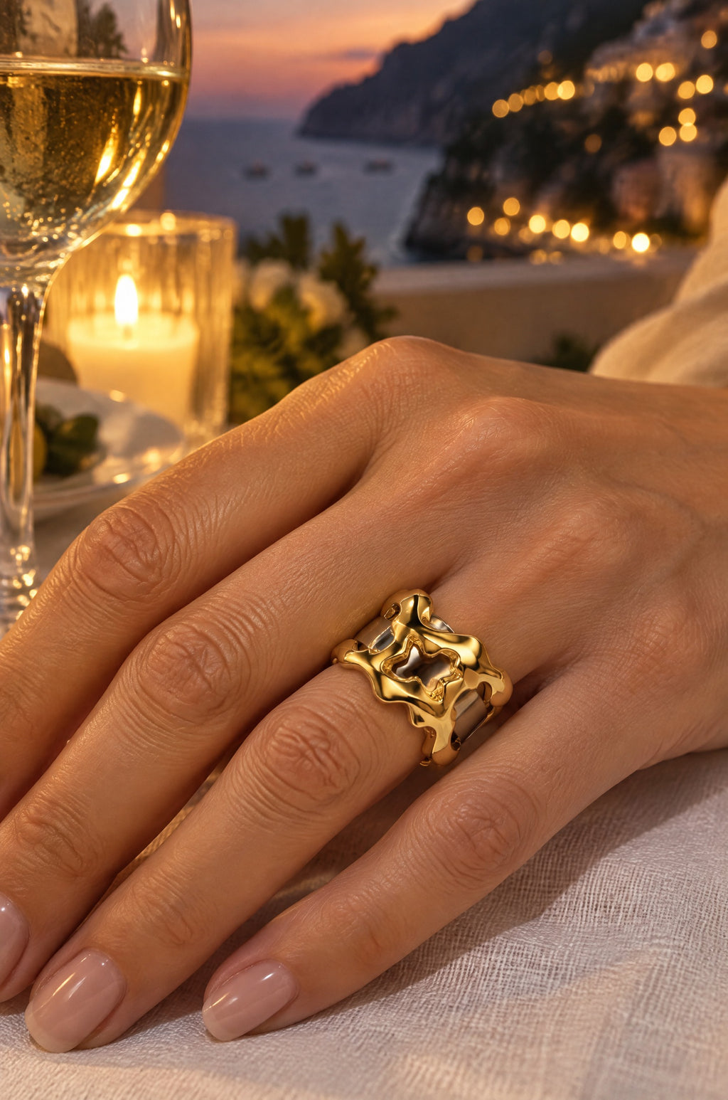 Woman at a seaside dinner wearing the gold Filicudi ring cover