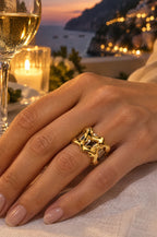 Woman at a seaside dinner wearing the gold Filicudi ring cover