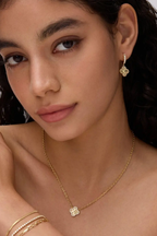 Fortuna clover earring worn with a matching clover necklace