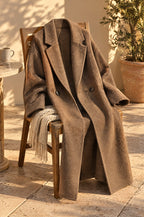 Sapri long coat, camel, on a chair