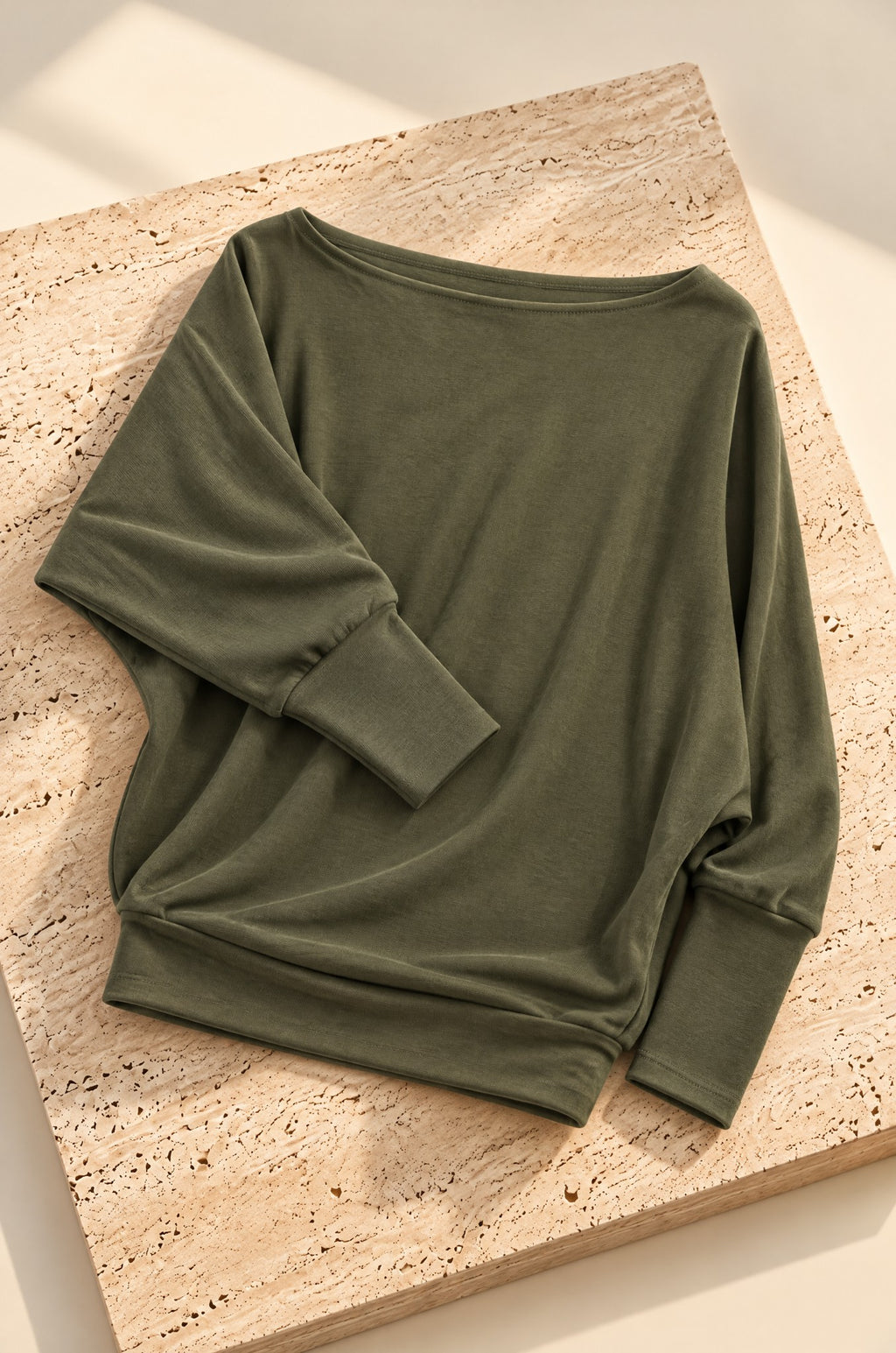 Scilla batwing top, olive, on travertine