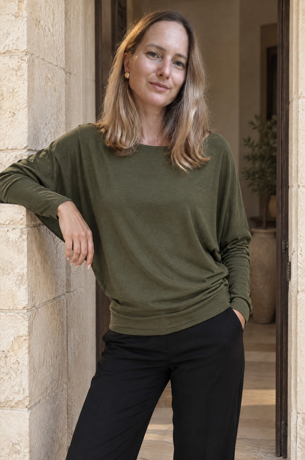 Scilla batwing top, worn in a doorway