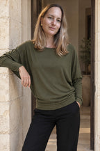 Scilla batwing top, worn in a doorway