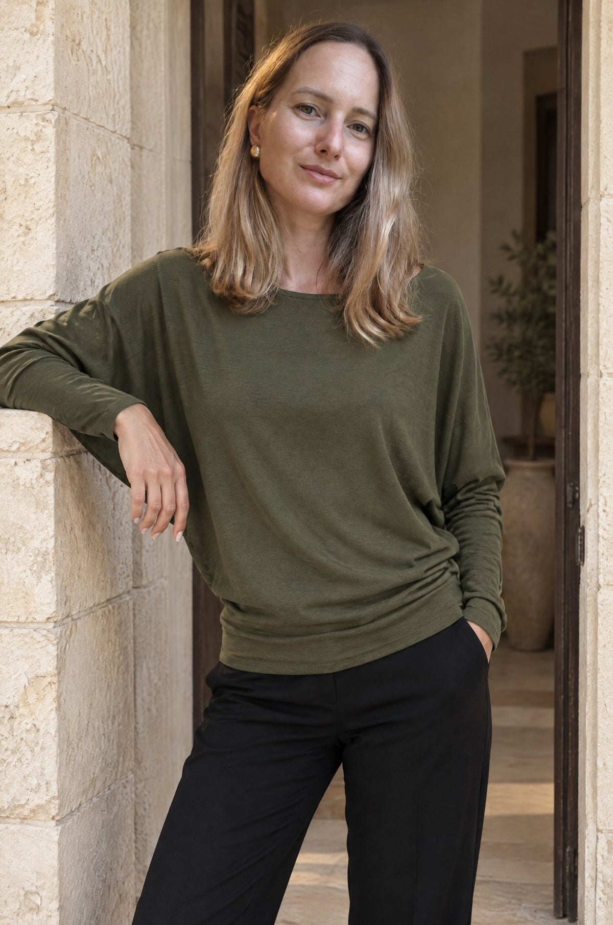 Scilla batwing top, worn in a doorway