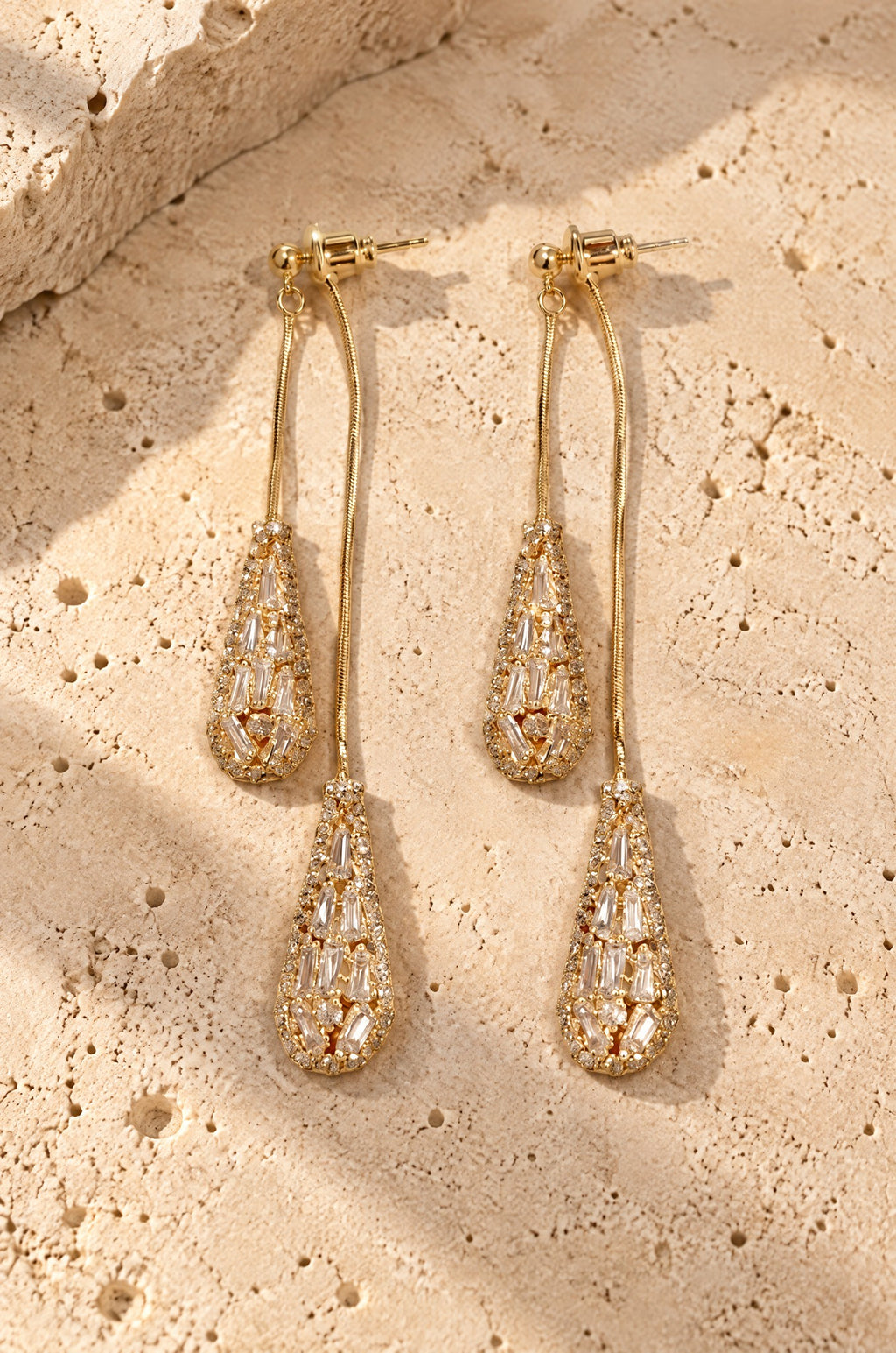 Fornillo drop earrings, gold, on travertine