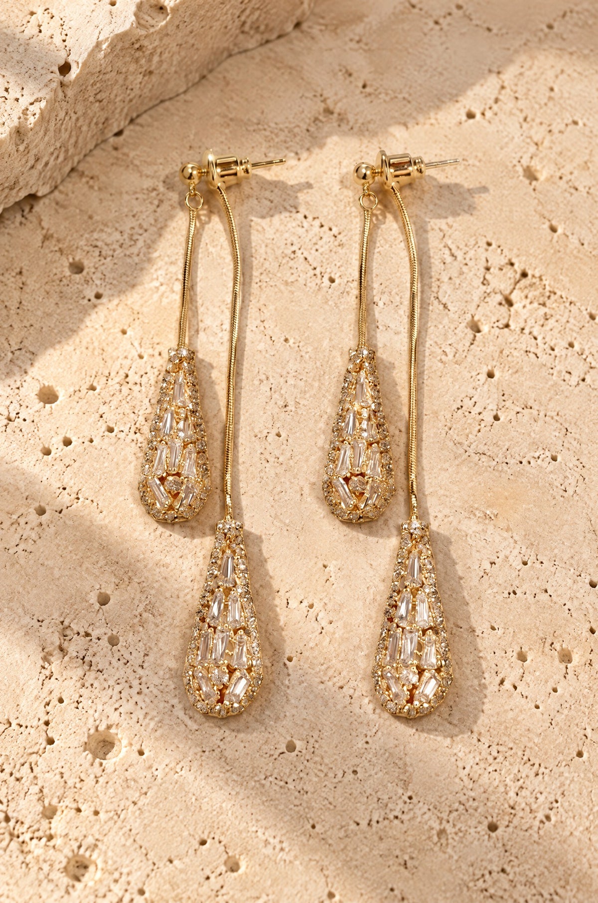 Fornillo drop earrings, gold, on travertine