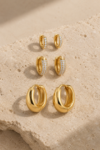 Scala hoop trio, three pairs of gold hoops on limestone