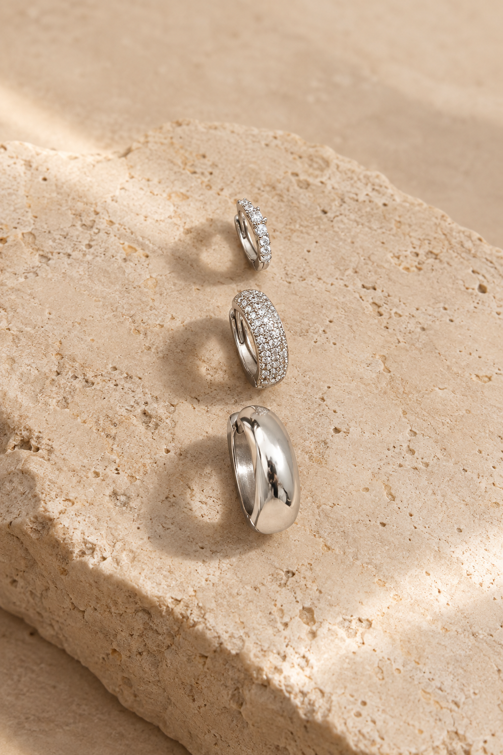 Scala hoop trio, three pairs of silver hoops on limestone