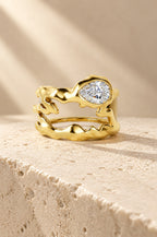 Vulcano ring cover in gold on travertine